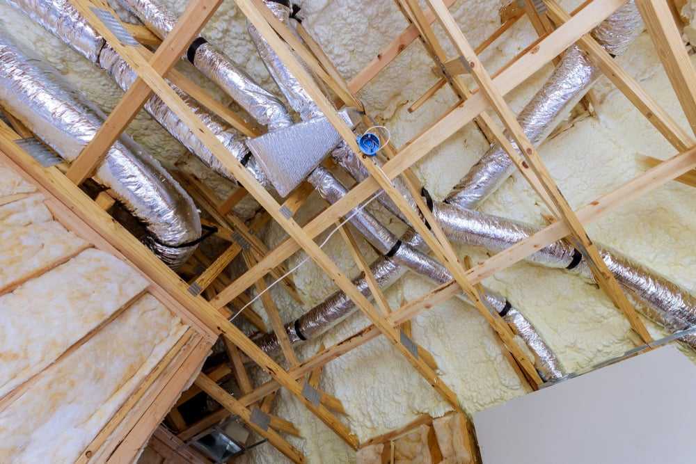 hole-home dehumidification system integrated with HVAC in a spray-foam insulated attic to manage latent heat loads in Baytown, TX.